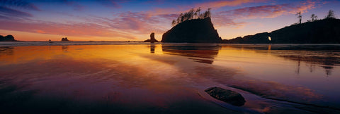 Silhouettes of the rock sea stacks and shoreline along Second Beach Washington at sunset
