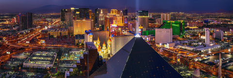 Rooftop view of the Las Vegas strip with the light of the Luxor hotel shining into the sky