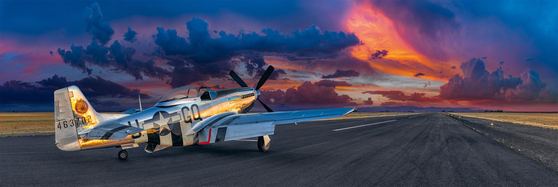 P51 Mustang airplane sitting on a runway in Aurora Oregon looking out at a cloud filled sky at sunset
