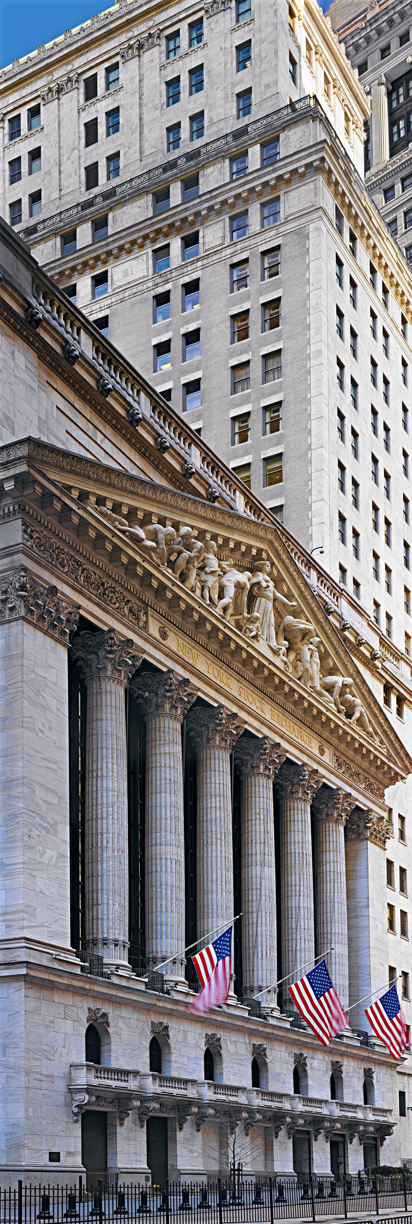 Stone pillars and architectural carvings on the exterior of a building on Wall Street New York